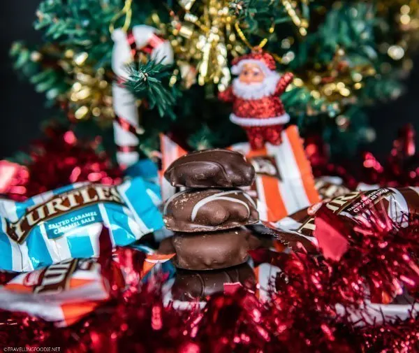 Original, Salted Caramel and Dark Chocolate TURTLES stacked on Christmas Decorations