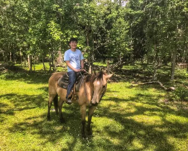 Raymond, the Travelling Foodie, riding a horse at Deep Creek Stables