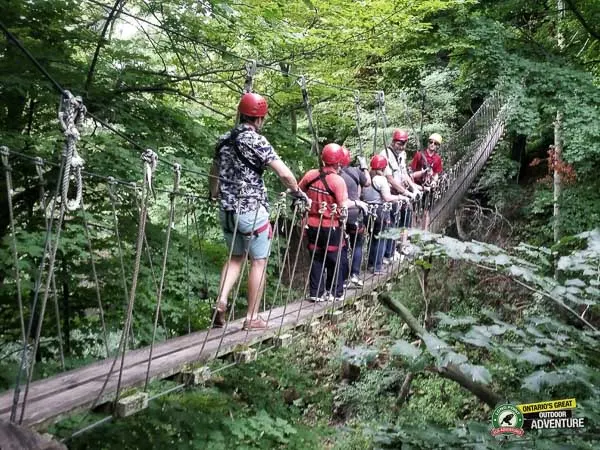 People walking on suspension skybridge at Long Point Eco Adventures in St. Williams, Norfolk County, Ontario