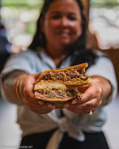 Felicia Lacalle holding Cuban Sandwich from Hemingway's at Armature Works in Tampa Bay, Florida