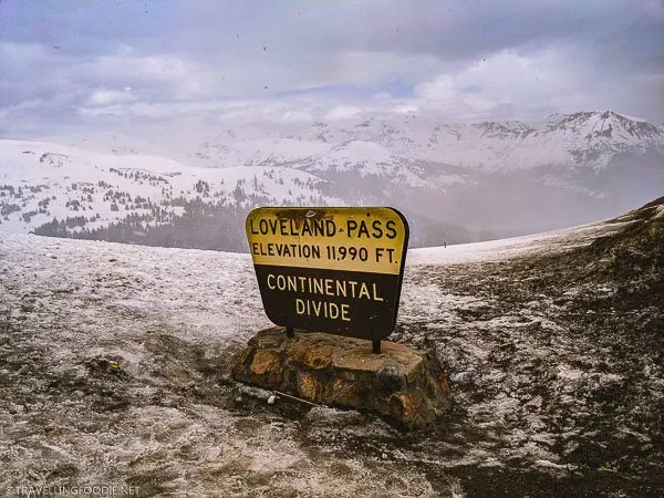 Loveland Pass Continental Divide Sign saying Elevation 11,990 feet in Colorado