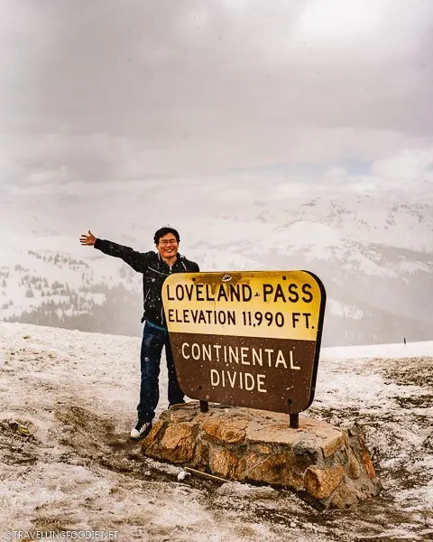 Travelling Foodie Raymond Cua at Loveland Pass Continental Divide Sign in Colorado