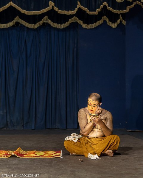 Indian Guy putting make-up for Kathakali Show at Greenix Village in Cochin, Kerala