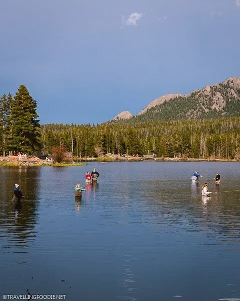 People fly fishing at Sprague Lake in Rocky Mountain National Park Colorado