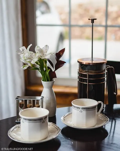Coffee, hourglass, flowers and two cups at Seasoned - An American Bistro in Estes Park