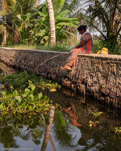 Indian lady fishing on Indian backwaters in Alleppey