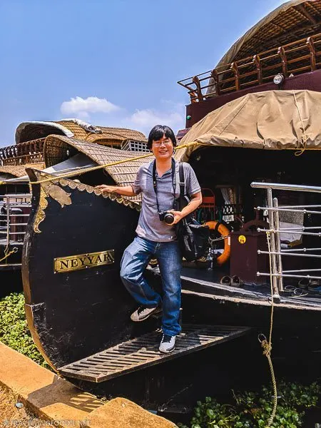 Travelling Foodie Raymond Cua standing on Xandari Riverscapes Houseboat in Alleppey