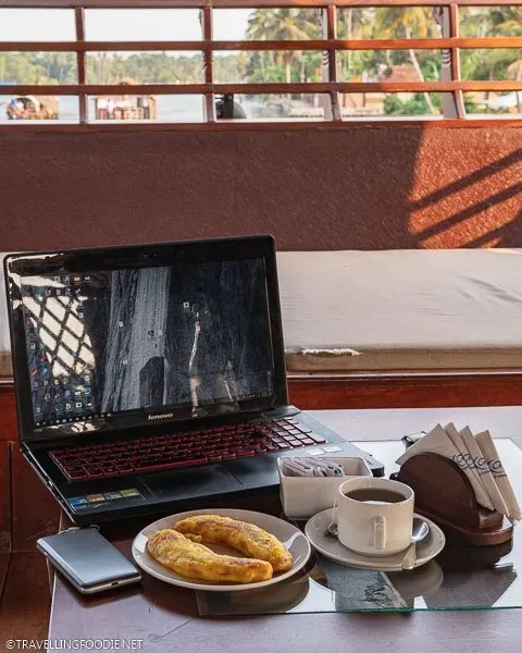 Plantain, Tea, Tep Wireless, Lenovo Laptop on table of Alleppey Houseboat