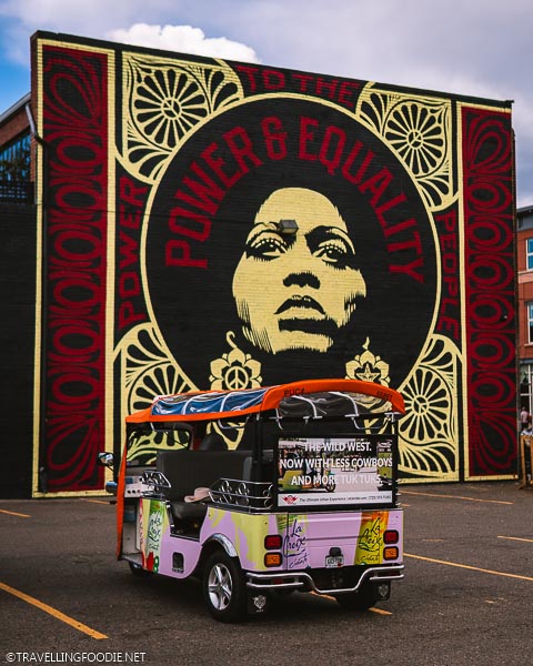 eTuk Ride parked by Power & Equality Mural in RiNo Art Alley in Denver