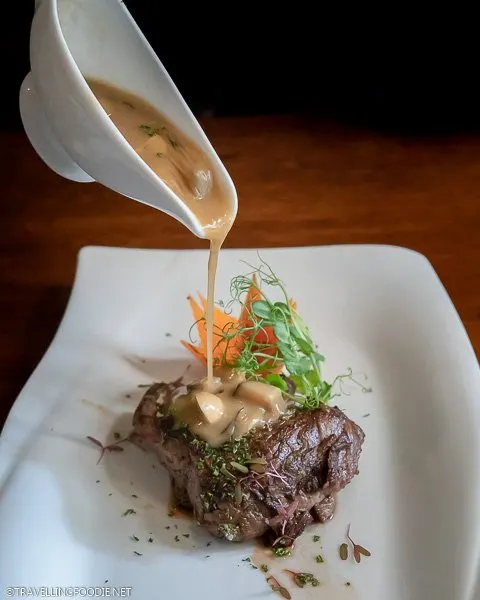 Pouring gravy on US Beef Tenderloin at Ilustrado Restaurant in Manila, Philippines
