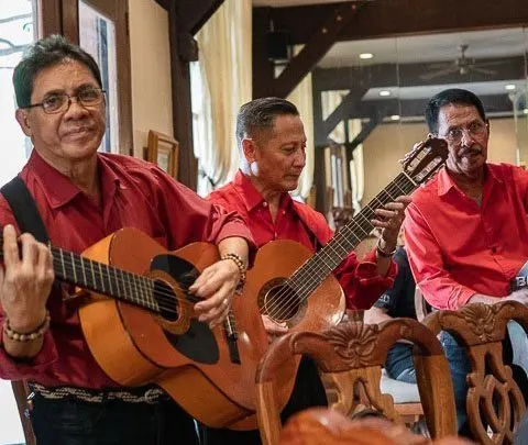 Three Musicians perform at a table at Ilustrado Restaurant in Manila