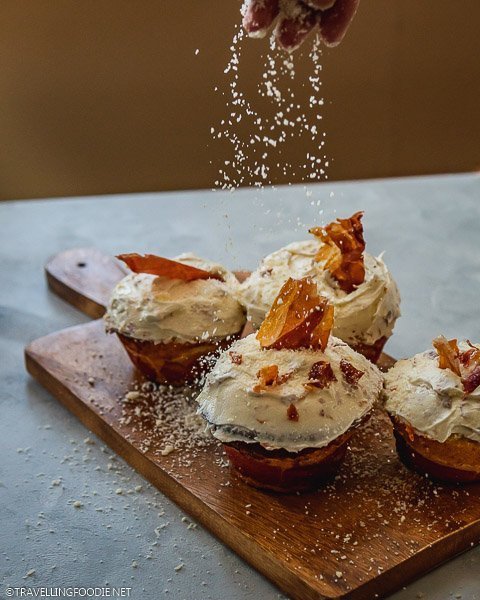 Sprinkling Grana Padano Cheese on Cheesecakes on Blanket