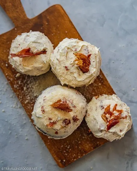 Flatlay four Cheese Cupcakes wrapped in Prosciutto topped with Prosciutto Buttercream and cheese sprinkles