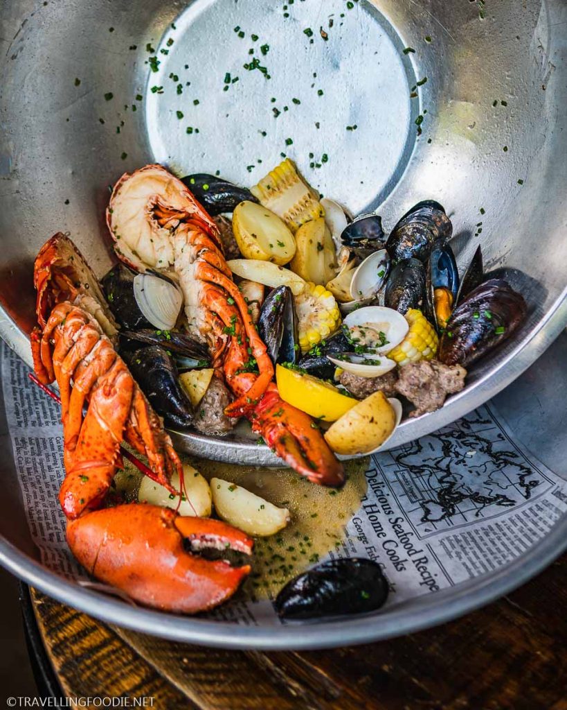 Pouring the Shellfish Boil on a platter at Shuck Halifax