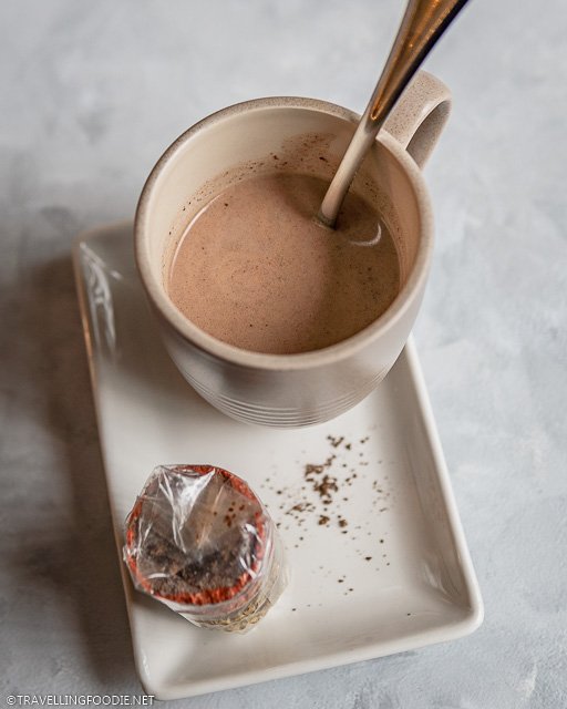 Filipino hot chocolate in a mug with tablea de cacao on the side
