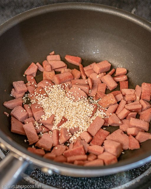Stir Fried Luncheon Meat topped with sesame seeds on pan