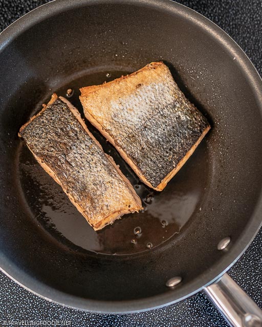 Two pan-seared salmon fillets with skin