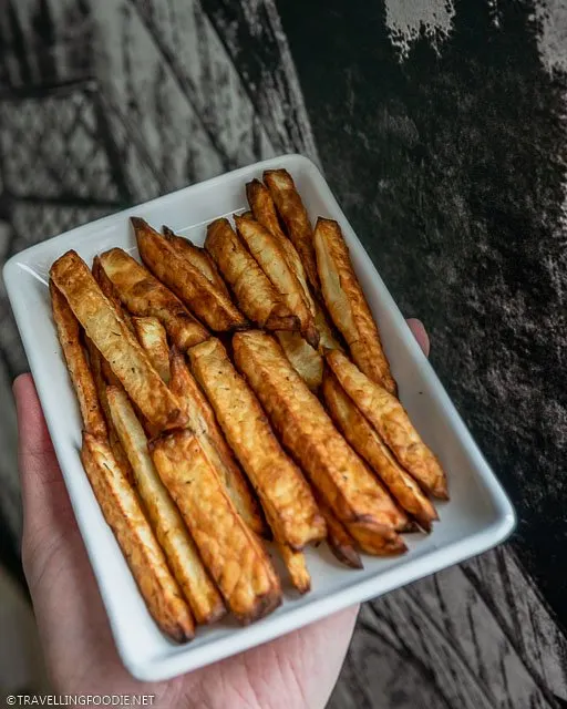 Holding a plate of homemade French Fries made with Air Fryer