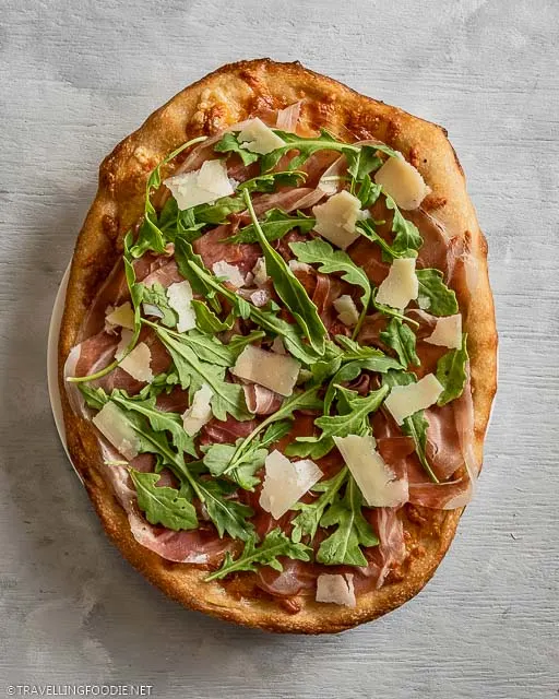 Whole Prosciutto and Arugula Cheese Italian Pizza on a Plate