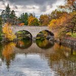 Ontario's oldest double-arch stone bridge during Fall at the Shakespearean Gardens in Stratford
