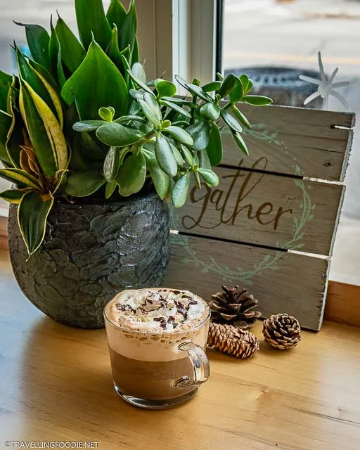 Double Mocha with plants and sign at The Livery Yard in Stratford, Ontario