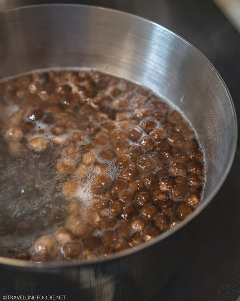 Boiling water with tapioca pearls on pot