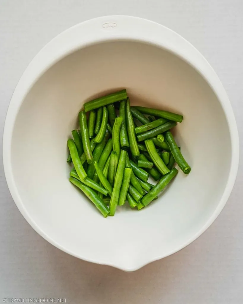 Green beans cut in half on a bowl