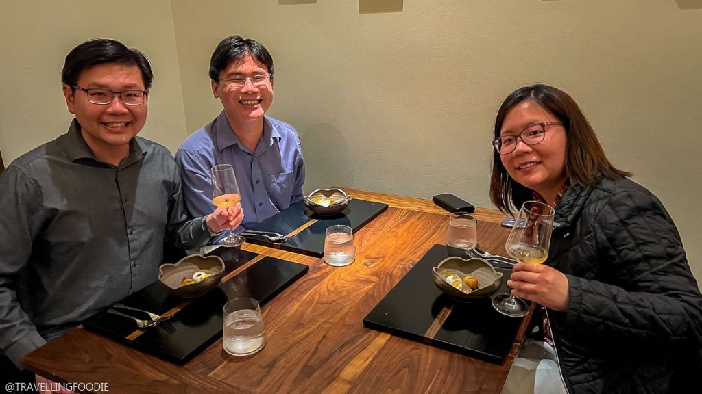Three people enjoying dinner at n/naka