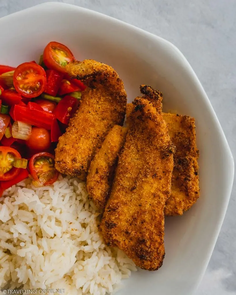 Air Fried Battered Basa Fish on Plate with Salsa Fresca and Rice