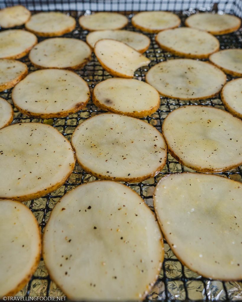 Sliced russet potato with oil, garlic salt