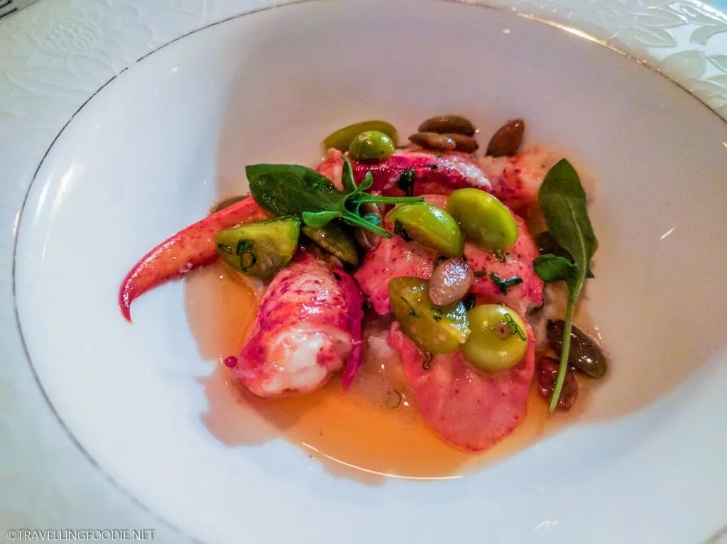 Fresh poached lobster dish with green tomatoes at Edulis, a top Toronto Michelin star restaurant.
