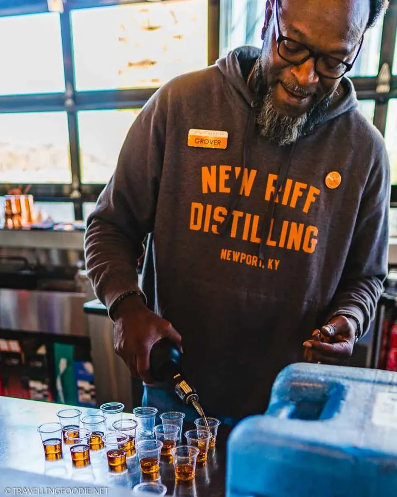Grover pouring whiskey at New Riff Distilling in Newport, Kentucky on The B-Line