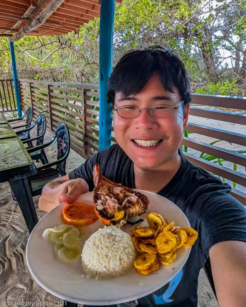 Travelling Foodie Raymond Cua holding lobster lunch plate at Playa Pilar Restaurant in Cayo Guillermo, Cuba