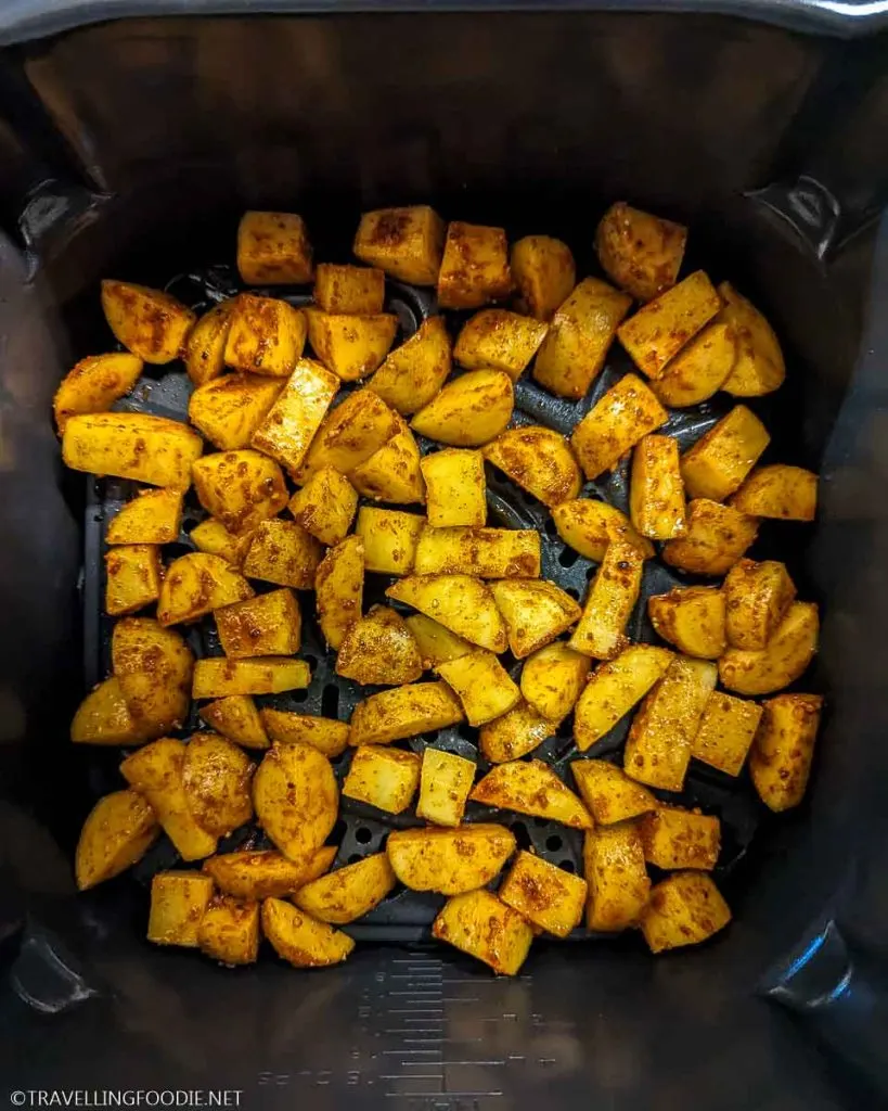 Seasoned raw potatoes on Ninja Speedi crisper tray
