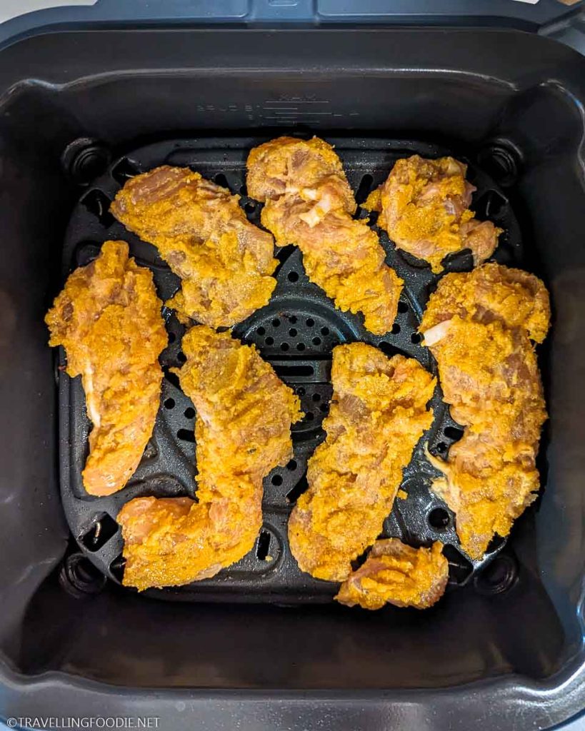 Raw & Breaded Seasoned Chicken Tenders on Crisper Tray