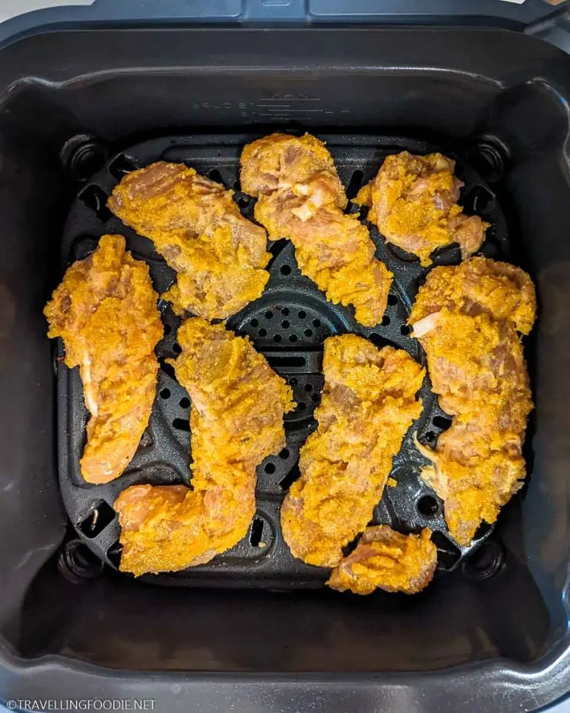 Raw & Breaded Seasoned Chicken Tenders on Crisper Tray