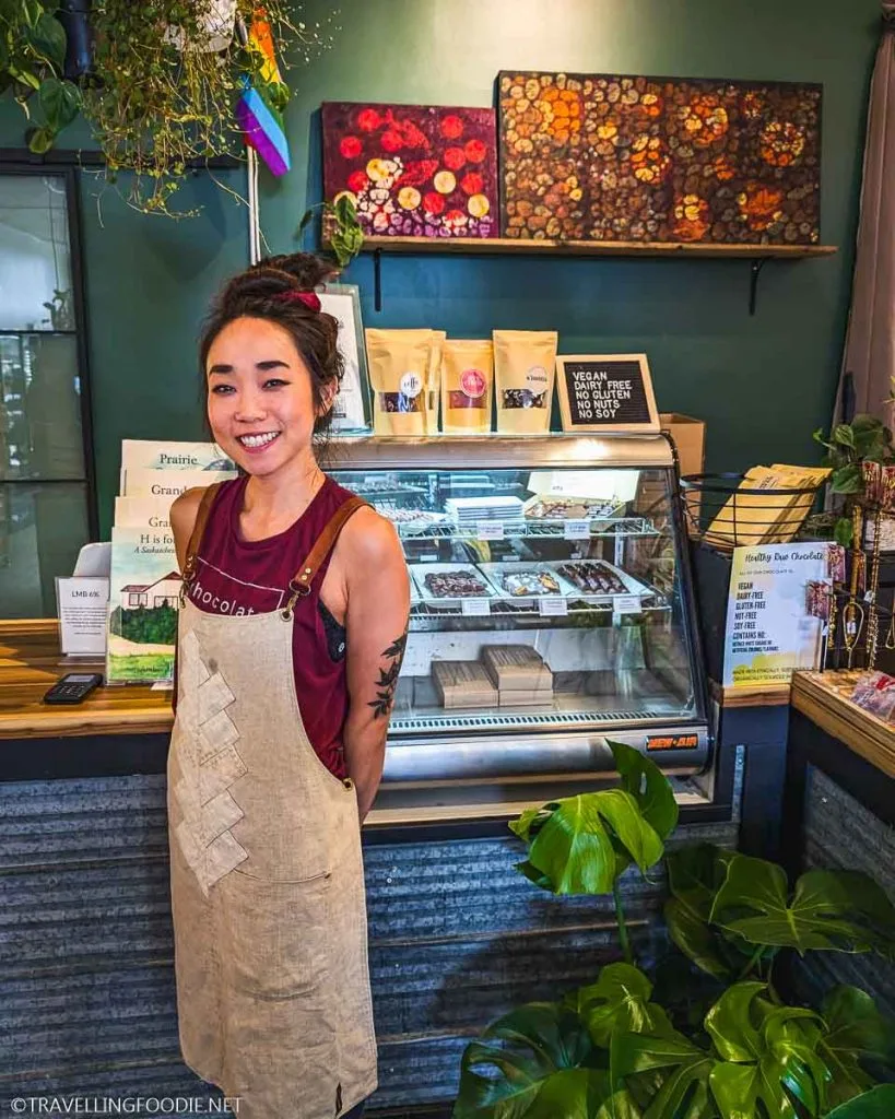 Julianna Tan posing inside The Little Market Box in Saskatoon