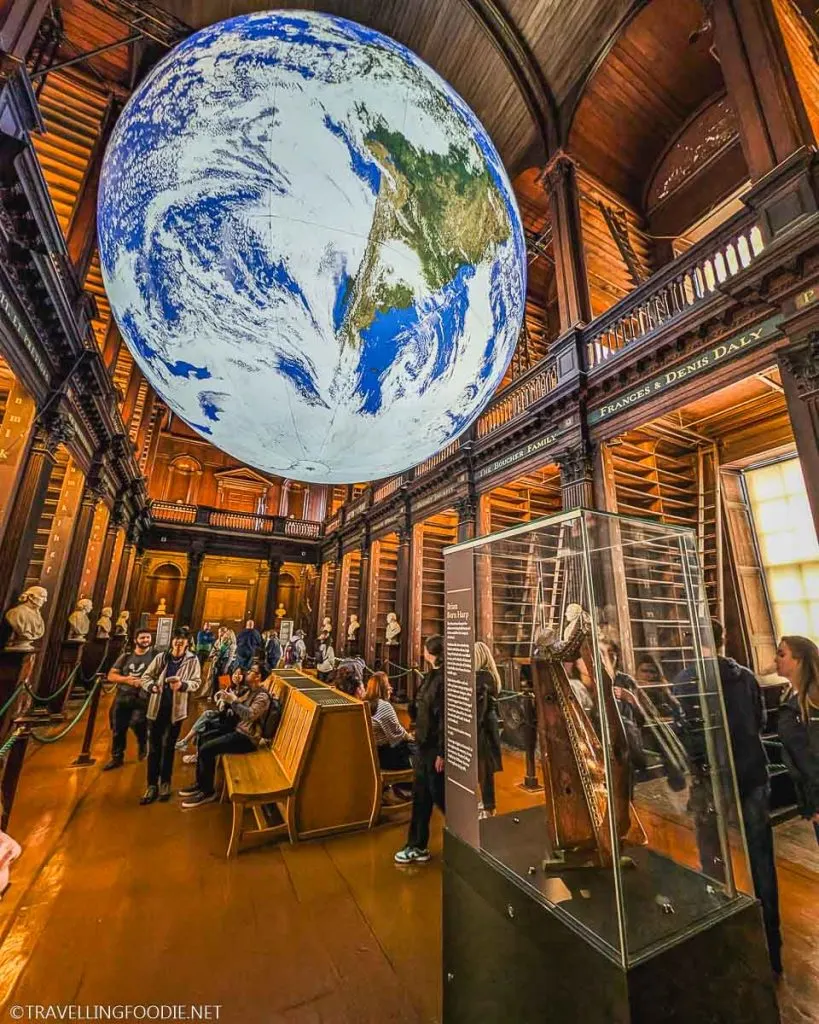 Brian Boru harp and Globe at The Long Room inside Old Library at Trinity College Dublin, Ireland
