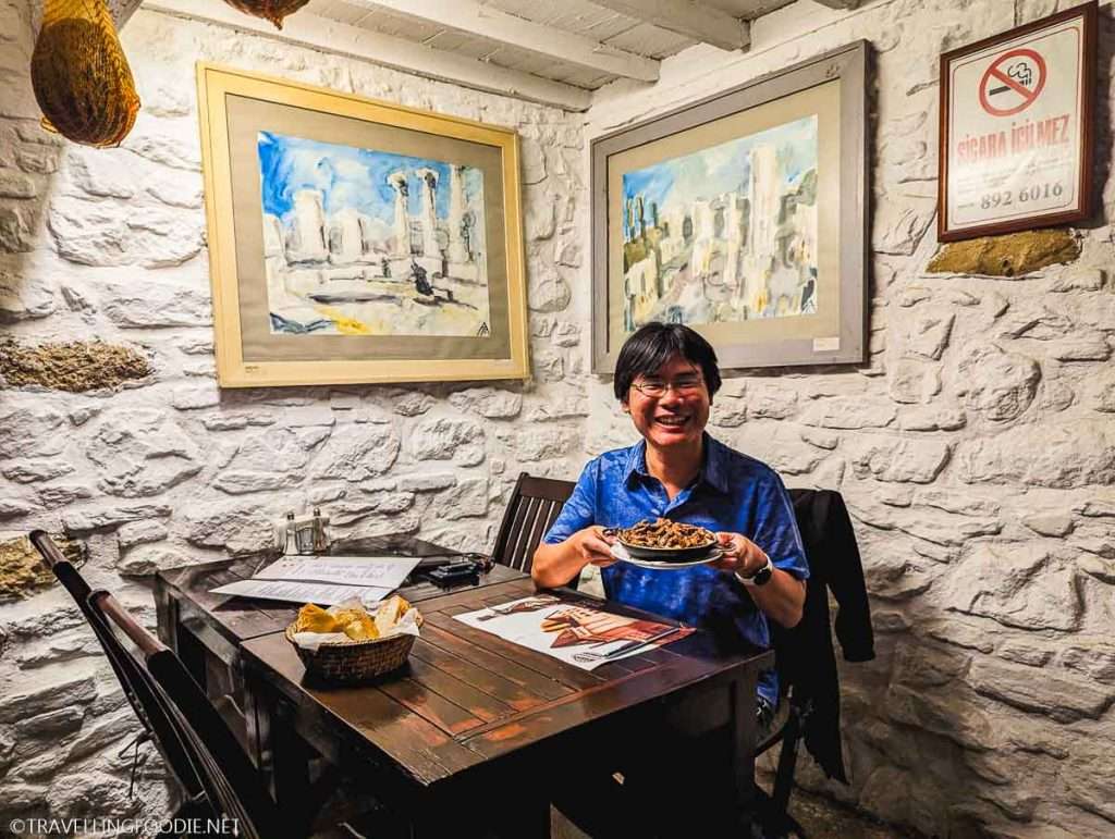 Travelling Foodie Raymond Cua holding cokertme kebab at Amazon Bistro Cafe in Selcuk, Turkey