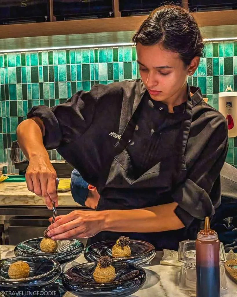 Chef making pani puri at Moonrise, One Michelin Star Restaurant in Dubai