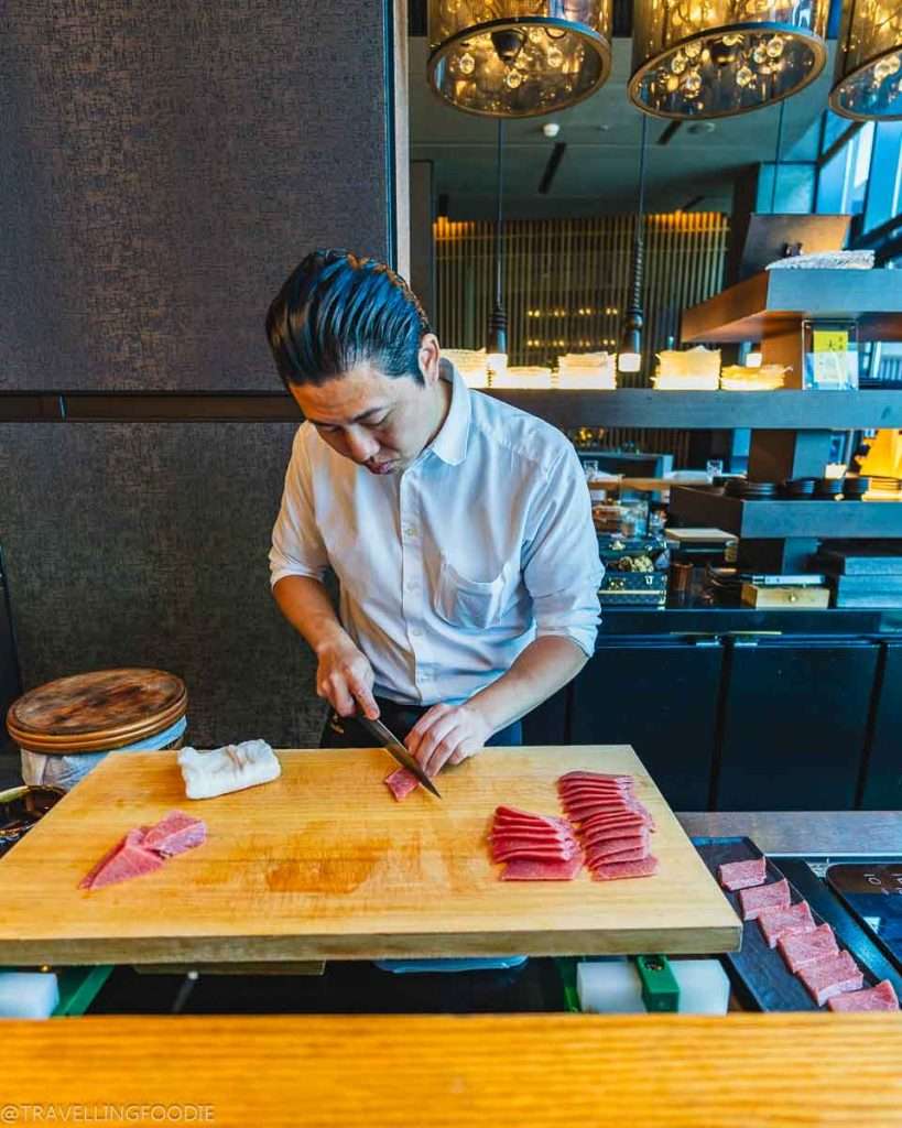Chef Takashi Namekata slicing sashimi at TakaHisa, Michelin Guide Recommended Restaurant at Banyan Tree Dubai Hotel