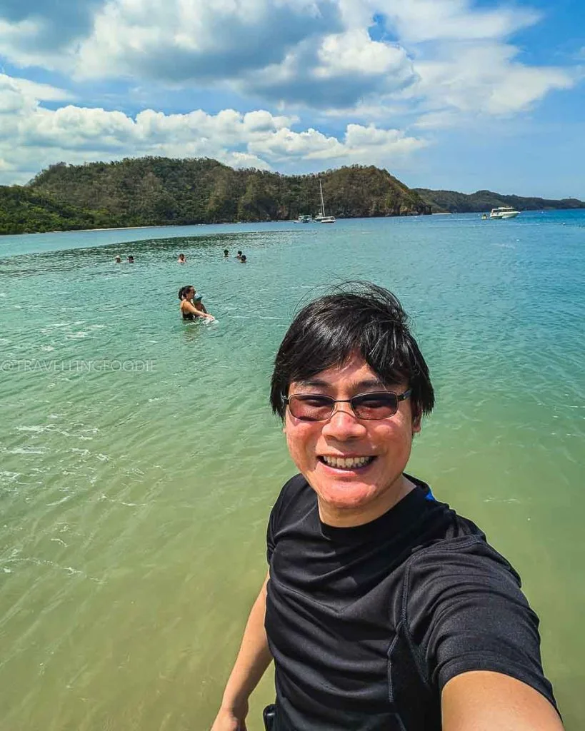 Travelling Foodie Raymond Cua on the water of Hamilo Coast Beach in Batangas