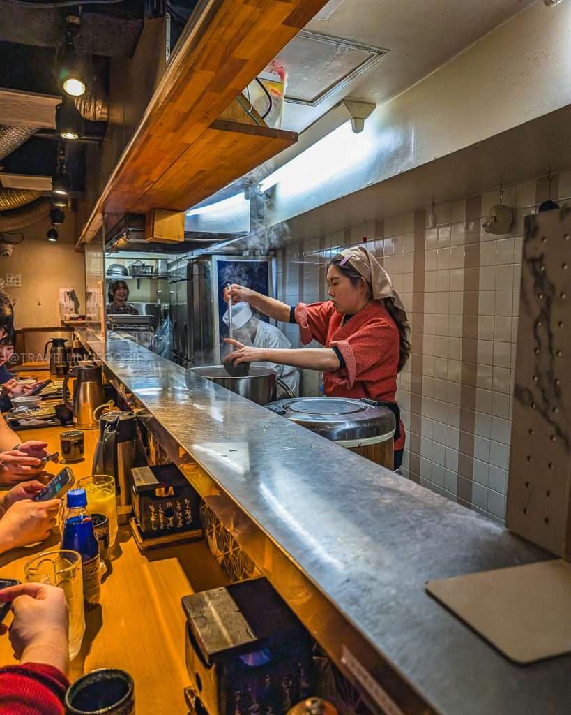 Staff pouring soup at Gyukatsu Ihora in Ikebukuro, Japan
