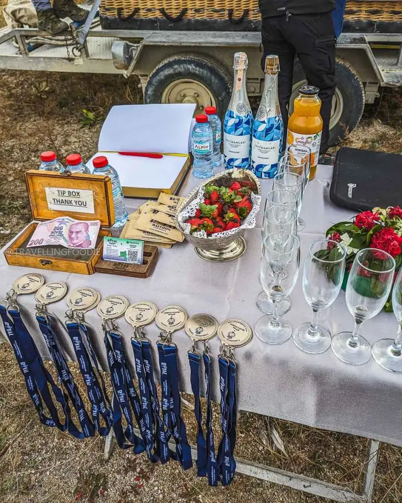 Champagne, Medals and Fruits after Royal Balloon landing in Goreme, Turkey