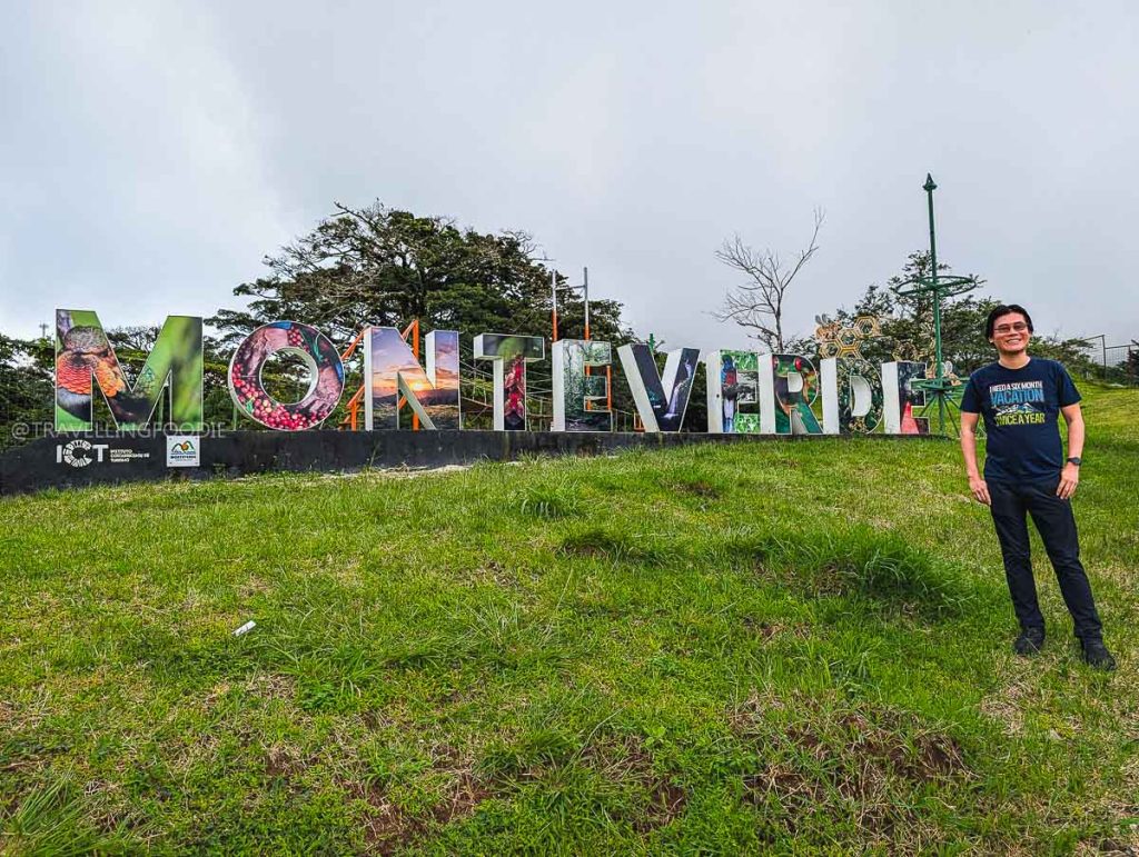 Travelling Foodie Raymond Cua with Monteverde Sign in Costa Rica road trip