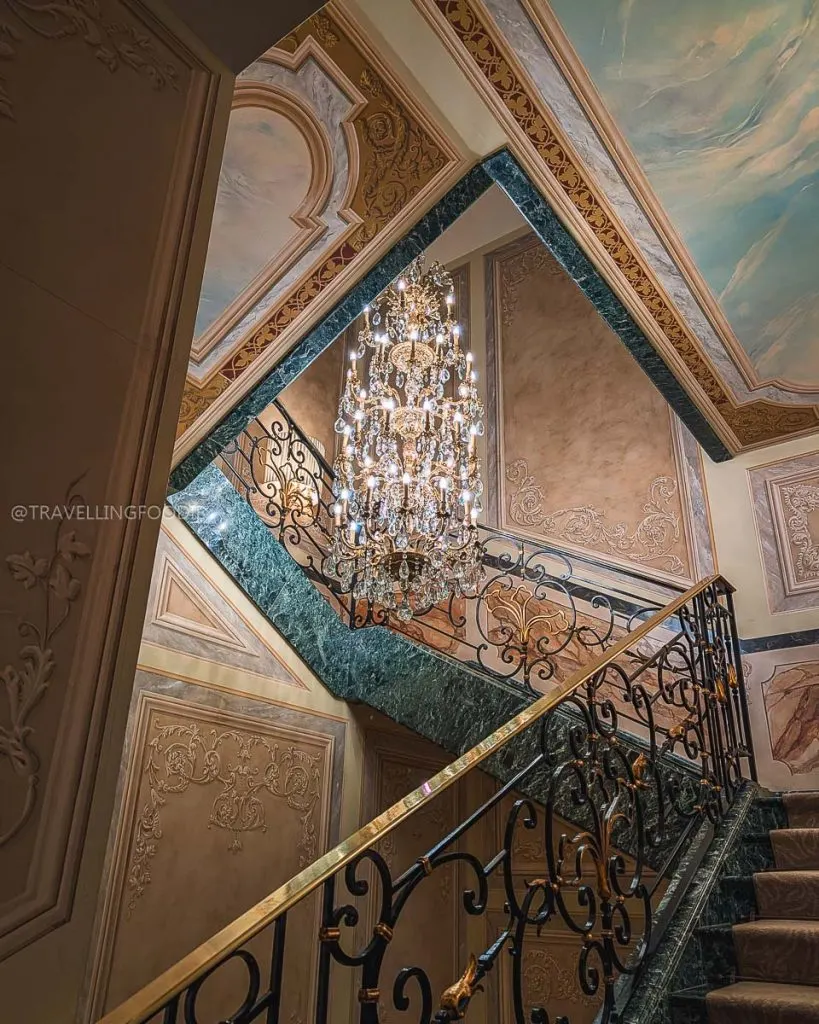 Luxury crystal chandelier and marble staircase inside Hotel Principe di Savoia in Milan Italy.