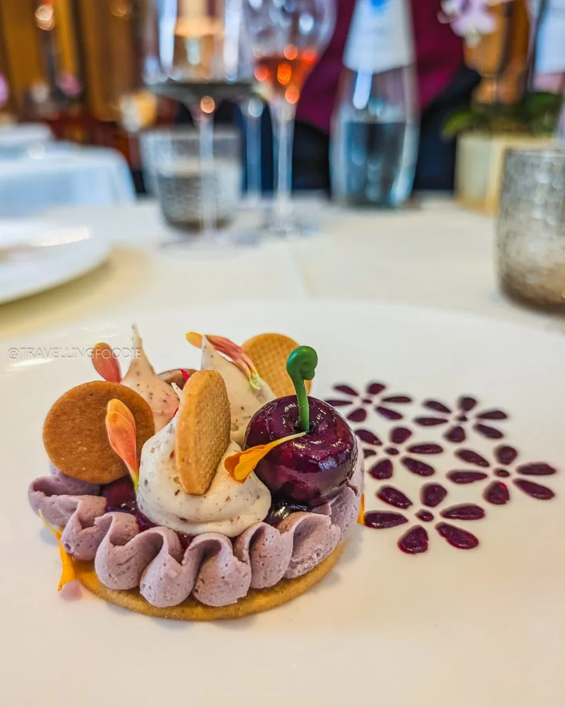 Almond sable biscuit dessert with cherry compote and artistic plating at Ristorante Acanto.