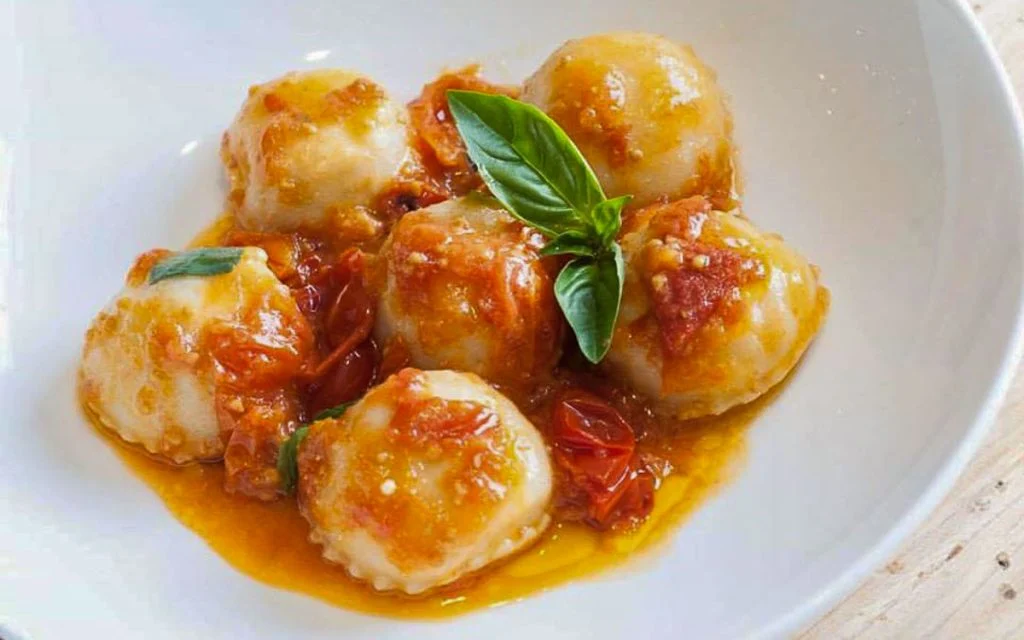 Authentic vegetarian Ravioli Caprese pasta topped with sweet Datterino tomato sauce.