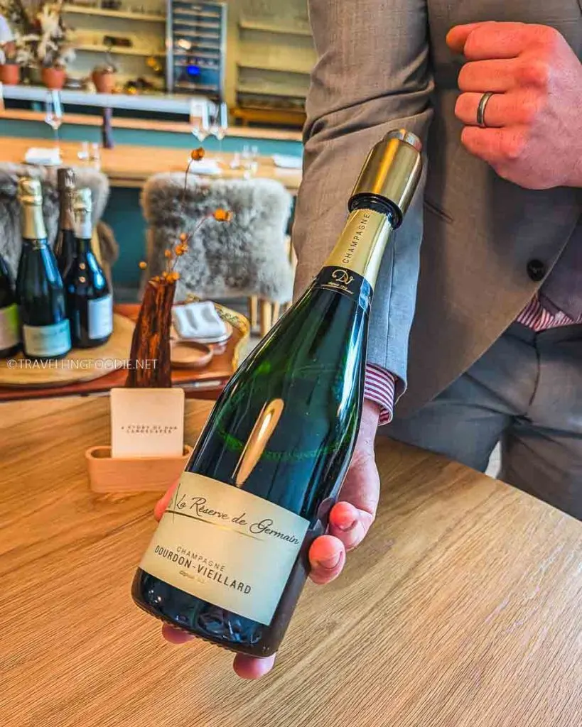 Bar Manager Eric presenting Dourdon Vieillard La R&eacute;serve de Germain Champagne at The Pine Michelin Star restaurant in Creemore.