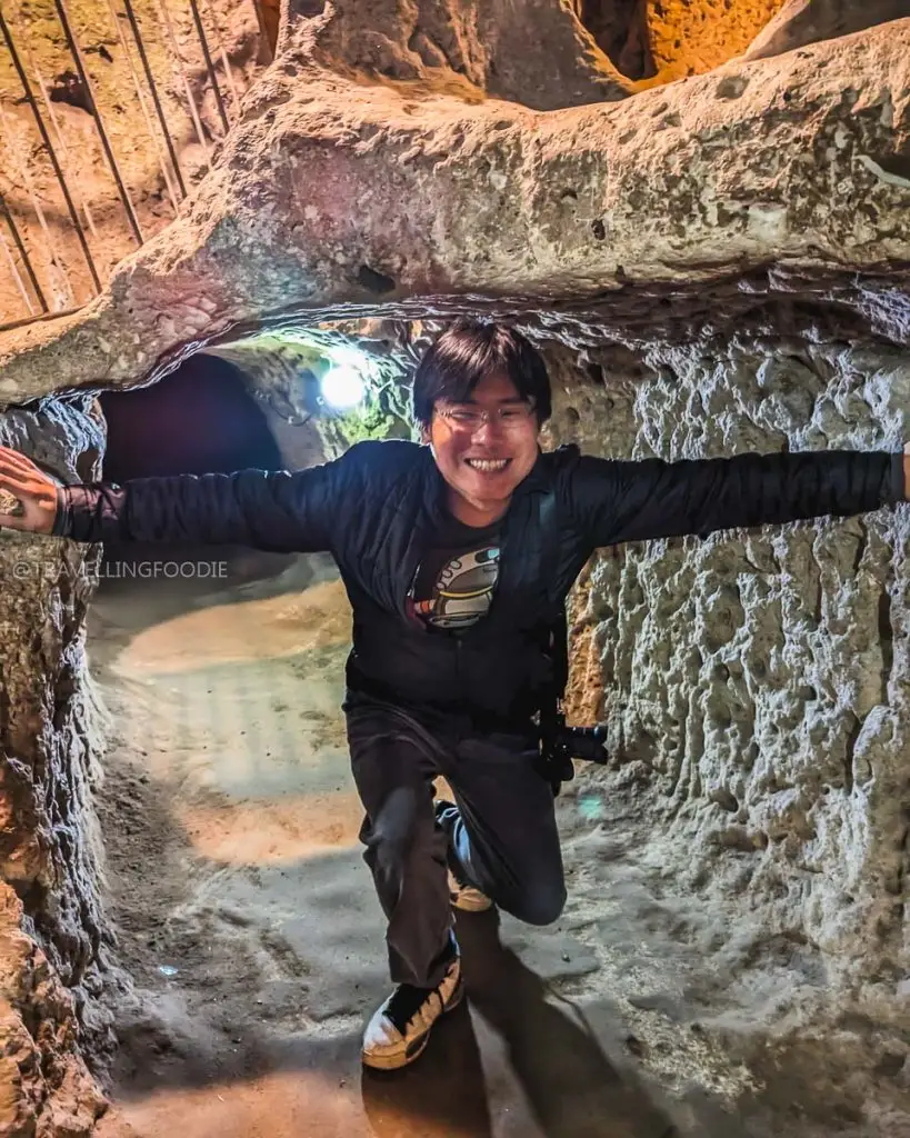 Travelling Foodie Raymond Cua showing the low ceilings and tight tunnels inside Derinkuyu Underground City on the Green Tour